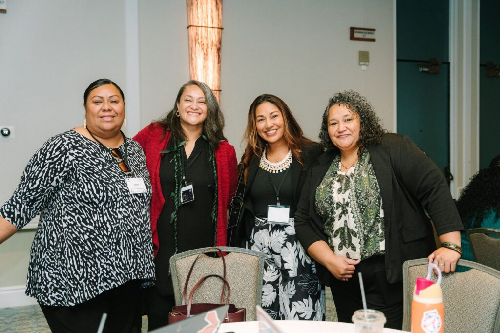 Four attendees smiling together at the EdTrust-West Education Equity Forum