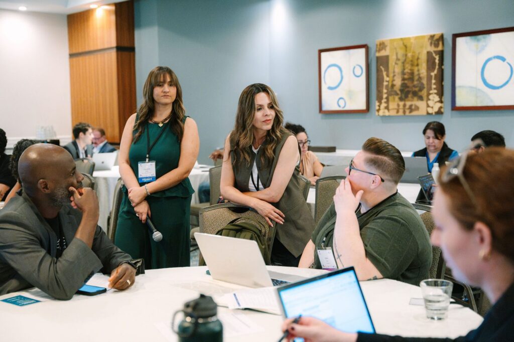Speakers leading a small-group discussion with attendees at a breakout session during the EdTrust-West Education Equity Forum