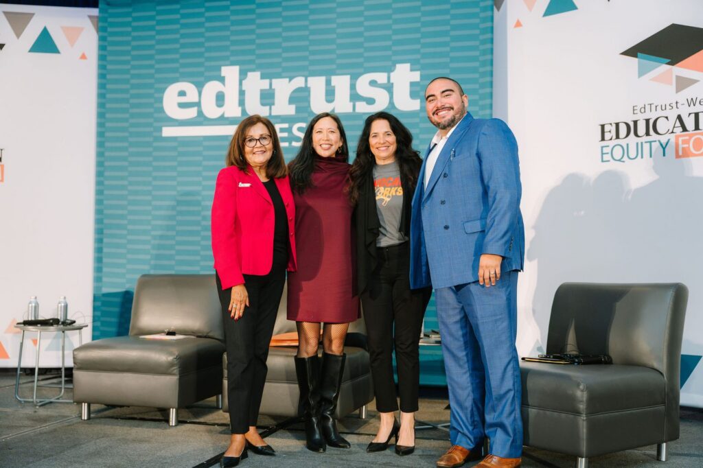 Closing plenary panelists standing together on stage in front of the EdTrust-West backdrop at the Education Equity Forum